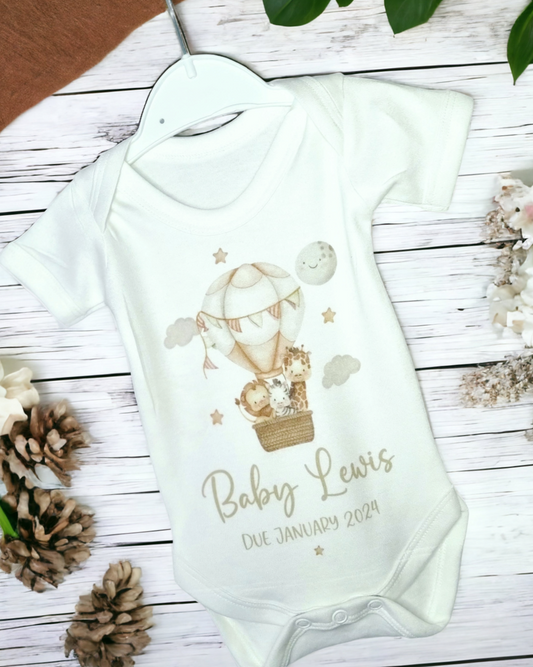 Personalised baby vest with hot air balloon design for pregnancy announcements and baby showers, featuring baby surname and 'hello world' outfit options, made from soft polyester-cotton blend, printed with safe inks.